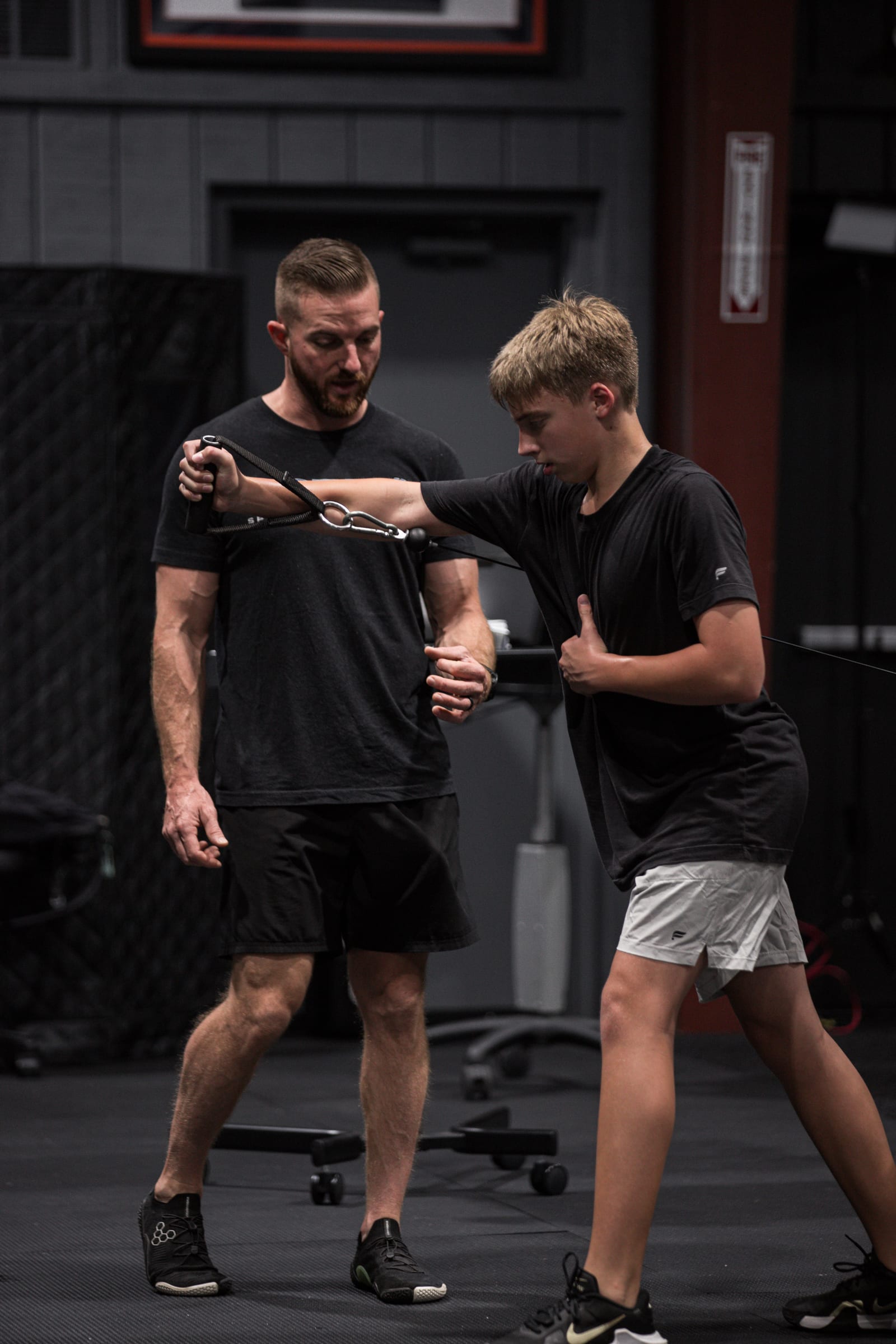 Coach correcting younger athlete